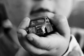 child holding toy car